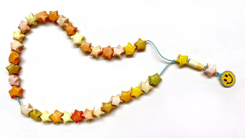 image of star-shaped paper worry beads looped on string