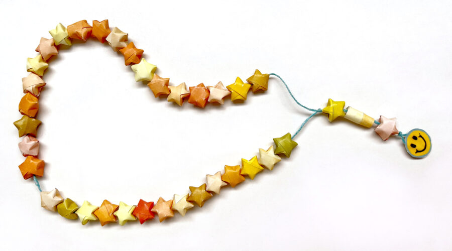 image of star-shaped paper worry beads looped on string