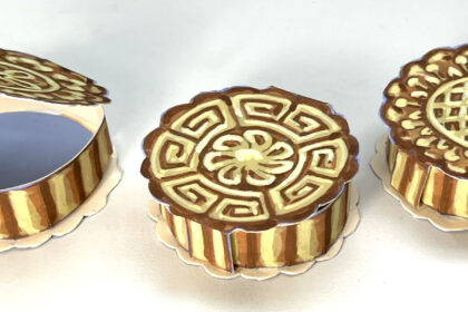 images of three handmade paper boxes that look like Chinese mooncakes