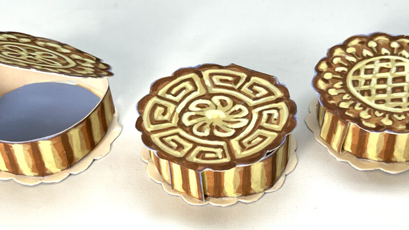 images of three handmade paper boxes that look like Chinese mooncakes