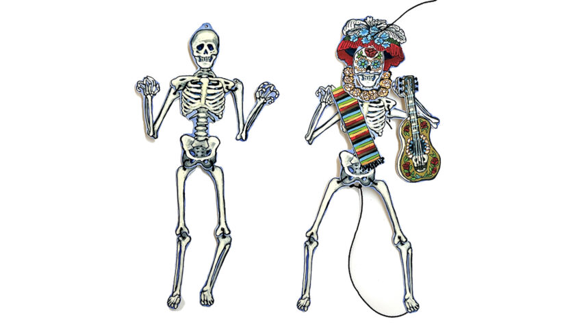 image of 2 small paper skeletons, one wearing a paper crown and holding a guitar and scarf