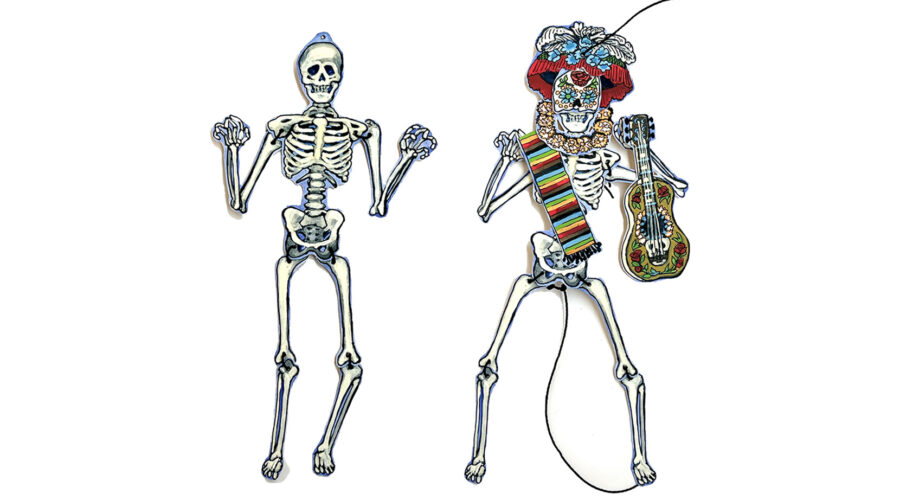 image of 2 small paper skeletons, one wearing a paper crown and holding a guitar and scarf