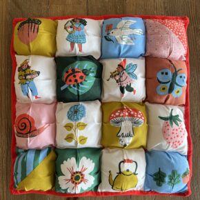 cute square puffy quilt featuring bright colors and cute storybook characters