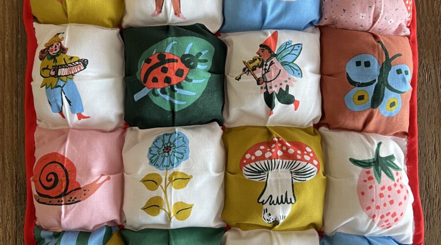 cute square puffy quilt featuring bright colors and cute storybook characters