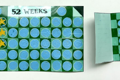 image of DIY scratch-off cards, on the left is a big card in blue ahnd green tones representing weeks of the year, and on the right is a small booklet with a similar grid to represent 1 week out of the year