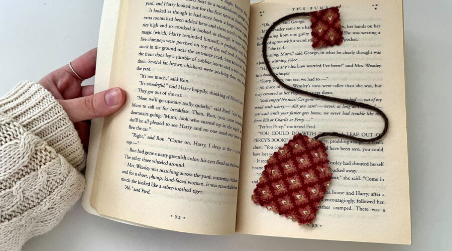 images of a hand opening a book with a tea-bag shaped bookmark inside