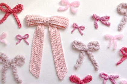 a flat lay of many pink crocheted bows in different shades and sizes and yarns