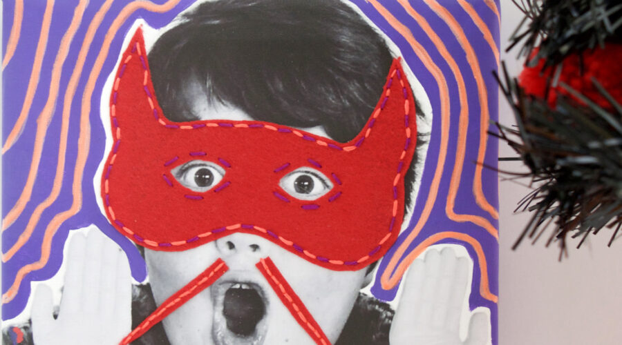 image of black and white photo of a child with a surprised face and mixed media felt and embroidered red mask and moustache for halloweenj