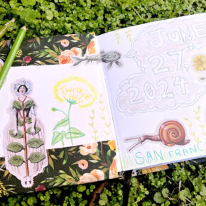 image of an open sketchbook on a bed of moss, pages revealing nature-inspired stickers and pencil drawings of flowers, snails, and strange creatures, plus colored pencils